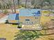 Aerial view showcases the home's layout, including the deck, backyard, and surrounding mature trees at 175 Ashley Dr, Fayetteville, GA 30214