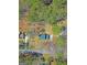 Aerial view of a house with a dark blue roof, surrounded by trees and greenery at 175 Ashley Dr, Fayetteville, GA 30214