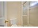 Bright bathroom featuring a white toilet and a glass-enclosed shower at 175 Ashley Dr, Fayetteville, GA 30214