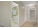 Hallway view to the bathroom featuring a tub, shower, and vanity at 175 Ashley Dr, Fayetteville, GA 30214