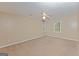 Carpeted bedroom with ceiling fan and windows allowing for natural light at 175 Ashley Dr, Fayetteville, GA 30214