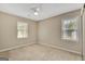 Bright bedroom with neutral paint, two windows, a ceiling fan, and carpet flooring at 175 Ashley Dr, Fayetteville, GA 30214