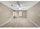 Neutral bedroom with carpet, two bright windows, and a ceiling fan at 175 Ashley Dr, Fayetteville, GA 30214