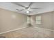 Spacious carpeted bedroom with a ceiling fan and natural light from two windows at 175 Ashley Dr, Fayetteville, GA 30214
