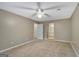 Spacious bedroom featuring carpet, a ceiling fan, and access to the en-suite bathroom at 175 Ashley Dr, Fayetteville, GA 30214
