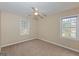 This bright bedroom has neutral carpet, a ceiling fan, and windows to let in natural light at 175 Ashley Dr, Fayetteville, GA 30214