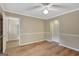 A bright, empty bedroom with white trim, modern floors, and a ceiling fan at 175 Ashley Dr, Fayetteville, GA 30214