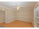 This bedroom features wood-look flooring, a lighted ceiling fan and a closet at 175 Ashley Dr, Fayetteville, GA 30214