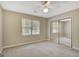 Bedroom showcasing a ceiling fan, carpet, window, and mirrored closet at 175 Ashley Dr, Fayetteville, GA 30214