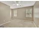 Bright bedroom features two windows, neutral paint, carpet, and a ceiling fan at 175 Ashley Dr, Fayetteville, GA 30214