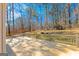 Large wooden deck with wood railing, set against a backdrop of mature trees and blue skies at 175 Ashley Dr, Fayetteville, GA 30214