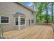 New, light colored wood deck with a bay window and exterior door at 175 Ashley Dr, Fayetteville, GA 30214