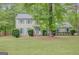 Charming two-story home with blue shutters, a well-manicured lawn, and mature shade trees at 175 Ashley Dr, Fayetteville, GA 30214