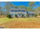 Charming two-story home with gray siding, blue shutters, manicured lawn, and inviting entryway at 175 Ashley Dr, Fayetteville, GA 30214