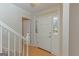 Bright foyer with hardwood floors, staircase, and view of the front door with sidelights at 175 Ashley Dr, Fayetteville, GA 30214