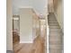 Bright foyer with wood floors, a staircase with white railings, and neutral walls at 175 Ashley Dr, Fayetteville, GA 30214
