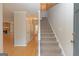 Bright foyer with hardwood floors, staircase, and doorway to a living space with a stone fireplace at 175 Ashley Dr, Fayetteville, GA 30214