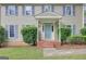 A close-up of a home's blue front door, flanked by meticulously trimmed hedges and decorative lighting at 175 Ashley Dr, Fayetteville, GA 30214