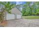 Attached two-car garage with concrete driveway and manicured lawn and mature trees at 175 Ashley Dr, Fayetteville, GA 30214