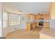 Eat-in kitchen features stainless appliances, a ceiling fan and an abundance of wood cabinets for storage at 175 Ashley Dr, Fayetteville, GA 30214