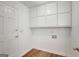Functional laundry room with ample storage cabinets and a clean, bright space at 175 Ashley Dr, Fayetteville, GA 30214