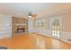 Living room features a stone fireplace, built-in shelving, and hardwood floors at 175 Ashley Dr, Fayetteville, GA 30214