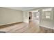 Empty living room with wood floors, a stone fireplace, and abundant natural light at 175 Ashley Dr, Fayetteville, GA 30214