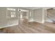 Spacious living room with light wood floors and views to dining room at 175 Ashley Dr, Fayetteville, GA 30214