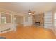 Spacious living room featuring hardwood floors, stone fireplace, and built-in shelving at 175 Ashley Dr, Fayetteville, GA 30214