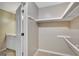 Spacious walk-in closet featuring rod and shelf storage, and carpet flooring at 175 Ashley Dr, Fayetteville, GA 30214