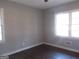 Bright bedroom featuring two windows and wood-look flooring at 1876 Sw Sandtown Sw Rd, Atlanta, GA 30311