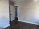 Simple bedroom featuring gray walls, dark flooring, and a doorway leading to another room at 1876 Sw Sandtown Sw Rd, Atlanta, GA 30311