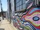 Exterior brick wall with a vibrant mural painted with a mix of colors and abstract designs at 1876 Sw Sandtown Sw Rd, Atlanta, GA 30311