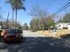 Peaceful street view with a parked SUV, a house with the street number, and mature trees at 1876 Sw Sandtown Sw Rd, Atlanta, GA 30311