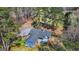Aerial view of the exterior showing the home's layout, deck, and wooded surroundings at 850 Coan Dr, Locust Grove, GA 30248