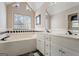 Well-lit bathroom featuring dual sinks and a large bathtub beneath a window at 850 Coan Dr, Locust Grove, GA 30248