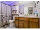 Bathroom featuring a cabinet vanity, toilet, and distressed-look shower curtain at 850 Coan Dr, Locust Grove, GA 30248