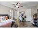 Bedroom with a ceiling fan, a window, wood-look floors, and a desk at 850 Coan Dr, Locust Grove, GA 30248