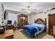 This bedroom features a ceiling fan, carpet, and a matching wooden dresser and bedframe at 850 Coan Dr, Locust Grove, GA 30248