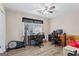Bedroom with a ceiling fan, window, and wood-look floors; use as office at 850 Coan Dr, Locust Grove, GA 30248