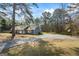 A cozy house with a porch, complimented by mature trees and a basketball court at 850 Coan Dr, Locust Grove, GA 30248