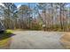 View of the home with a basketball court in the backyard at 850 Coan Dr, Locust Grove, GA 30248