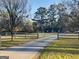 Scenic view of a tree-lined driveway leading to a cozy home in a serene setting at 850 Coan Dr, Locust Grove, GA 30248