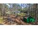 Exterior view of a home nestled in a wooded area, showcasing a green shed at 850 Coan Dr, Locust Grove, GA 30248