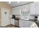 Functional kitchen with white cabinets, sleek countertops, and stainless steel appliances at 850 Coan Dr, Locust Grove, GA 30248