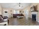 Bright living room featuring a fireplace, ceiling fan, and hardwood floors at 850 Coan Dr, Locust Grove, GA 30248
