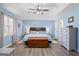 Spacious main bedroom featuring tray ceilings, a ceiling fan, and wood-look floors at 850 Coan Dr, Locust Grove, GA 30248