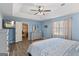 Spacious main bedroom featuring tray ceilings, a ceiling fan, and wood-look floors at 850 Coan Dr, Locust Grove, GA 30248