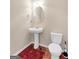 Powder room featuring a pedestal sink, toilet, and framed oval mirror at 7019 Diamond Dr, Rex, GA 30273
