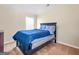 Cozy bedroom features neutral paint, a window, and carpet flooring at 7019 Diamond Dr, Rex, GA 30273